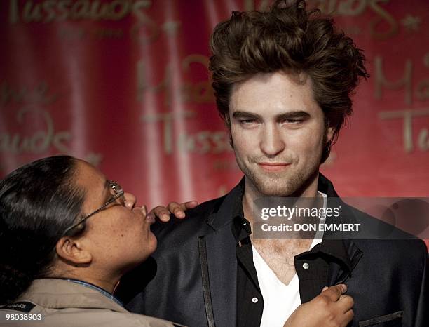 Fan blows a kiss to a wax figure of Hollywood heartthrob Robert Pattinson March 25, 2010 at Madame Tussauds in New York. The Twilight vampire and...