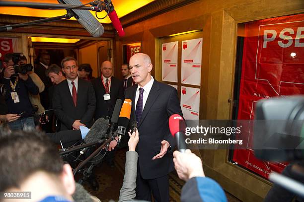 George Papandreou, Greece's prime minister, center, speaks to the media ahead of the European Socialist Party meeting in Brussels, Belgium, on...