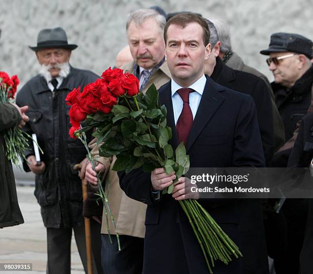 Russian President Dmitry Medvedev prepares to lay roses at Mamayev Hill�s Eternal Flame, a World War II memorial, on March 25, 2010 in Volgograd,...