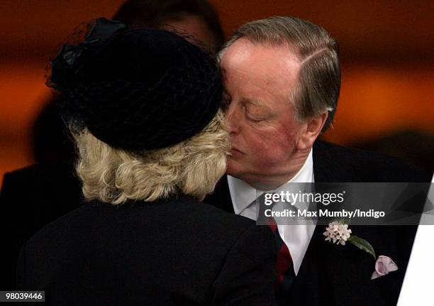 Camilla Duchess of Cornwall kisses ex-husband Andrew Parker Bowles as they attend a memorial service for Andrew's late wife Rosemary Parker Bowles at...