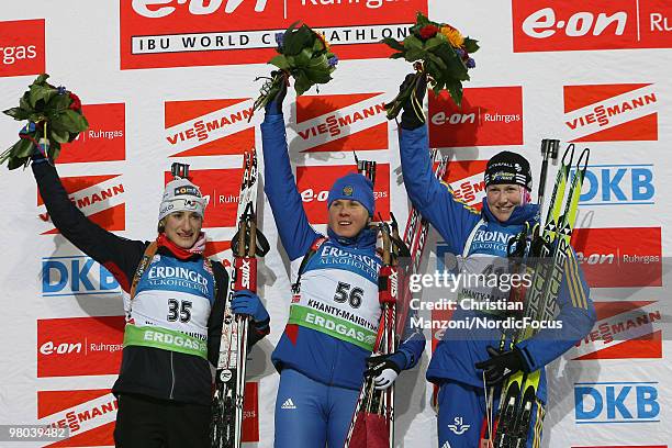 Marie Lauret Brunet of France , Iana Romanova of Russia and Helena Jonsson of Sweden celebrate after the women's sprint in the E.On Ruhrgas IBU...