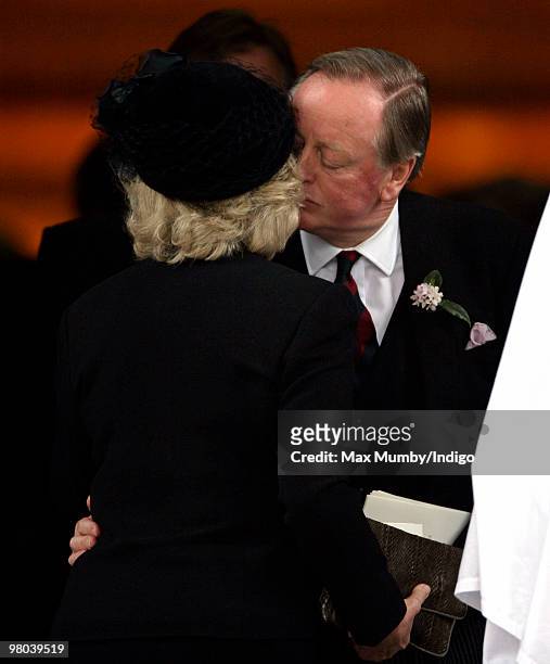 Camilla Duchess of Cornwall kisses ex-husband Andrew Parker Bowles as they attend a memorial service for Andrew's late wife Rosemary Parker Bowles at...