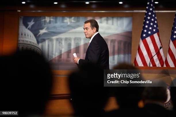 House Minority Leader John Boehner walks away from the podium as reporters shout questions during his weekly news conference at the U.S. Capitol...