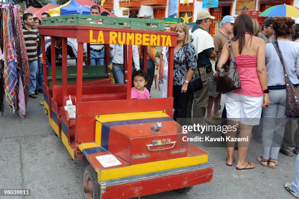 Little girl on a wooden mini bus in main square during Salento festival. The Paisas are a people who inhabit a region over the northwest Colombia in...