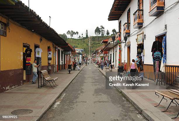 Main street with coloorful hoses and green hills in the background. Salento is a small town in the hills near the city of Pereira. It is known for...