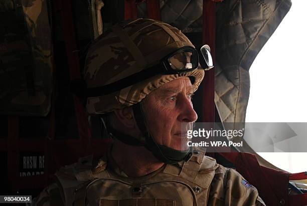 Prince Charles, Prince of Wales looks through the window of a British military helicopter enroute to Lashkar Gah on March 25, 2010 in Afghanistan....