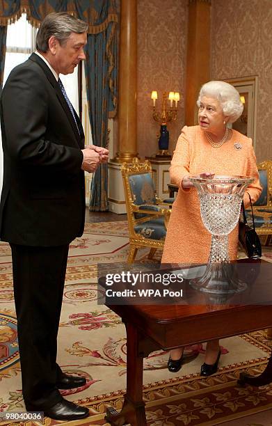 The President of the Republic of Slovenia, Dr Danilo Turk, presents Britain's Queen Elizabeth II with Rogaska Crystal during a visit to Buckingham...