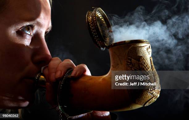 Victoria Crake specialist at Lyon & Turnbull blows smoke through a pipe carved with Napoleon�s double eagle armorial crest on March 25, 2010 in...