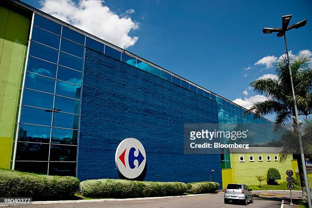 Car enters the parking lot for a Carrefour store in Sao Paulo, Brazil, on Sunday, March 7, 2010. Wal-Mart Stores Inc. Says it will spend $1.2 billion...