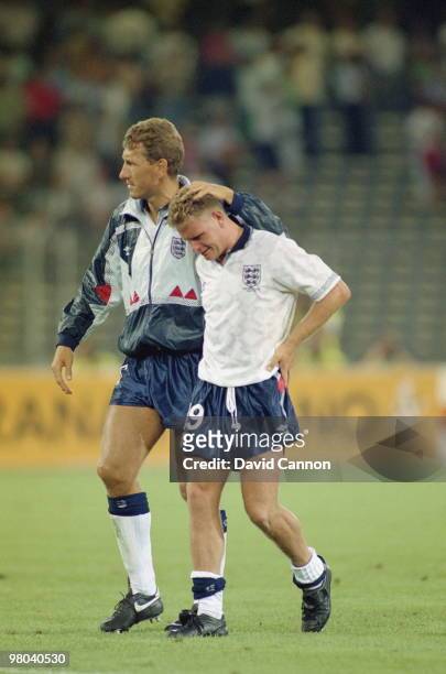 Paul Gascoigne of England bursts into tears and is consoled by tea mate Terry Butcher after losing the FIFA World Cup Finals 1990 Semi-Final match...