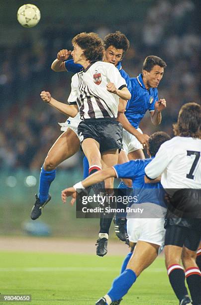 Paulo Maldini of Italy is challenged in mid air by Peter Schoettel of Austria during their Group A match during the 1990 FIFA World Cup on 9 June...