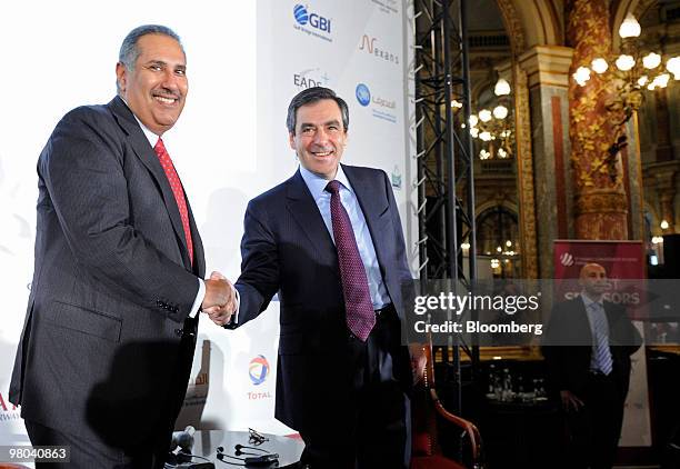 Francois Fillon, France's prime minister, right, and Sheik Hamad bin Jassim bin Jabor Al Thani, Qatar's prime minister, shake hands at the fifth...