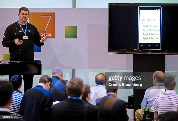 Erik Helgersen, left, demonstrates Microsoft Corp.'s Windows 7 Series prototype phone during the Cellular Telecommunications Industry Association...