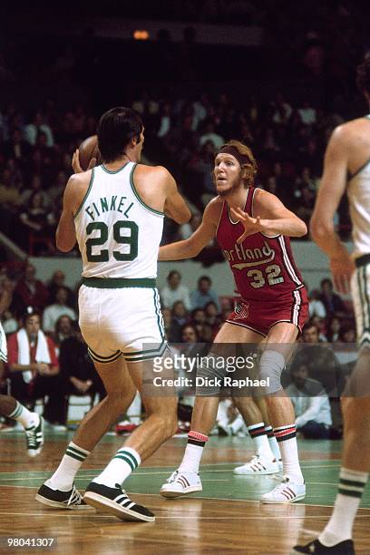 Bill Walton of the Portland Trail Blazers defends against Henry Finkel of the Boston Celtics during a game played in 1977 at the Boston Garden in...