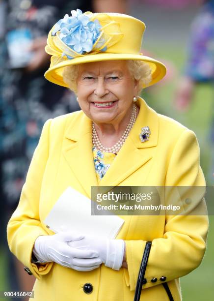 Queen Elizabeth II watches her horse 'Fabricate' run in the Wolferton Stakes on day 1 of Royal Ascot at Ascot Racecourse on June 19, 2018 in Ascot,...