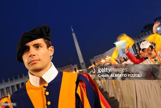 Swiss guard stands in St.Peters square at the Vatican on March 25, 2010 before the arrival of Pope Benedict XVI for a meeting with the youth of Rome...