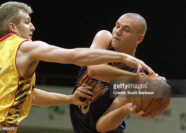 Scott McGregor of West Sydney is confronted by Andrew Gaze of Melbourne Tigers during the National Basketball League match between the West Sydney...
