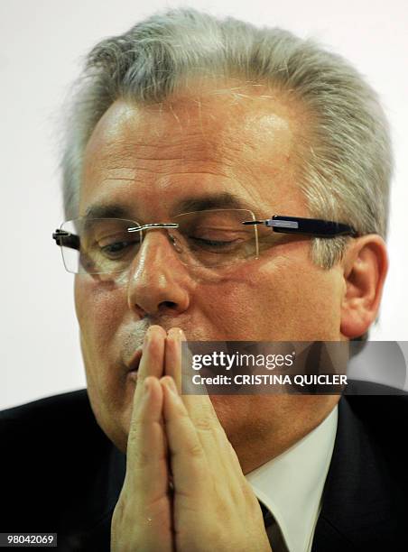 Spanish Judge Baltasar Garzon adjusts his glasses during a press conference in Seville on March 25, 2010. Garzon is the subject of a writ filed by a...