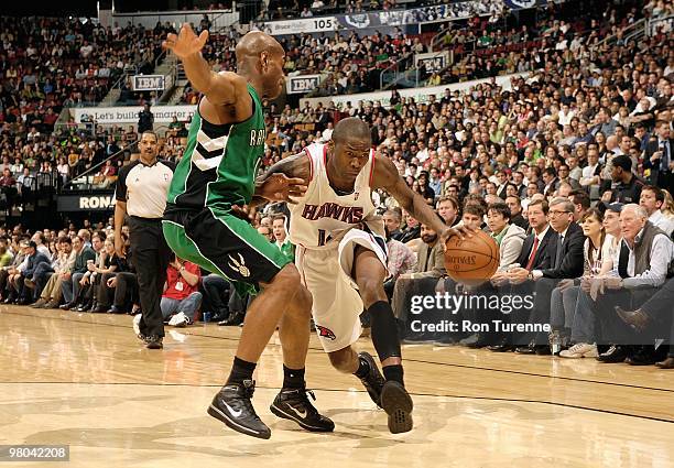 Jamal Crawford of the Atlanta Hawks drives against Jarrett Jack of the Toronto Raptors during the game on March 17, 2010 at Air Canada Centre in...