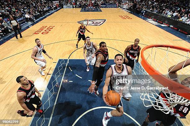 Devin Harris of the New Jersey Nets takes the ball to the basket past LaMarcus Aldridge of the Portland Trail Blazers during the game on February 23,...