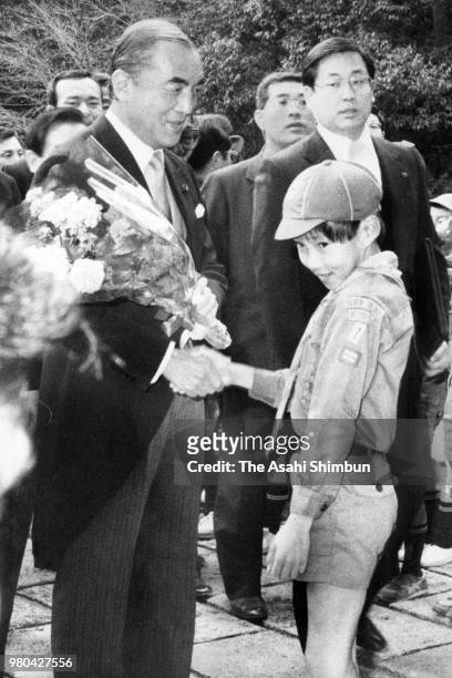 Prime Minister Yasuhiro Nakasone shakes hands with a child during his visit the Ise Shrine on January 4, 1987 in Ise, Mie, Japan.