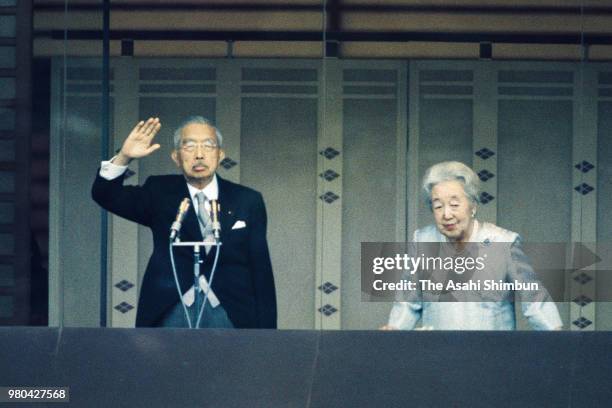 Emperor Hirohito and Empress Nagako wave to well-wishers during the New Year Celebration at the Imperial Palace on January 2, 1987 in Tokyo, Japan.