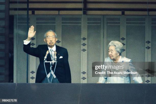 Emperor Hirohito and Empress Nagako wave to well-wishers during the New Year Celebration at the Imperial Palace on January 2, 1987 in Tokyo, Japan.