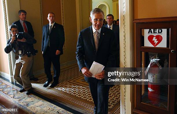 Senate Majority Leader Harry Reid leaves the Senate chamber on his way to a press conference following the U.S. Senate passage of the reconciliation...