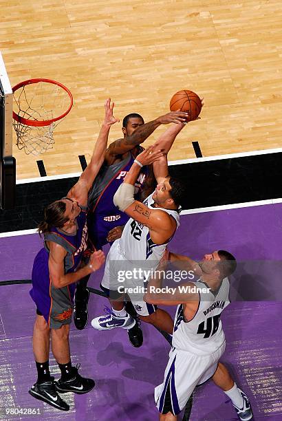 Sean May of the Sacramento Kings goes to the basket against Earl Clark and Louis Amundson of the Phoenix Suns during the game on February 5, 2010 at...