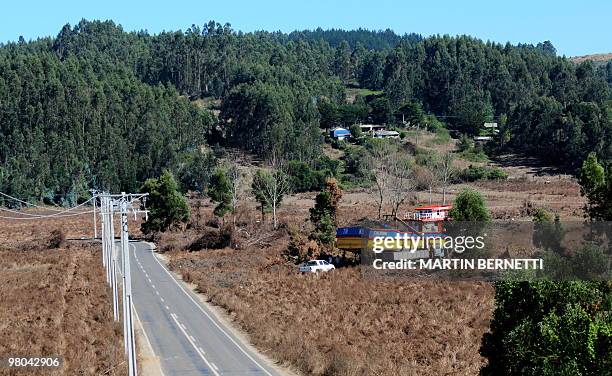 Fisshing boat is seen among a field on March 23, 2010 at the Dichato seaside resort, some 460 km south of Santiago, placed there by the February 27th...