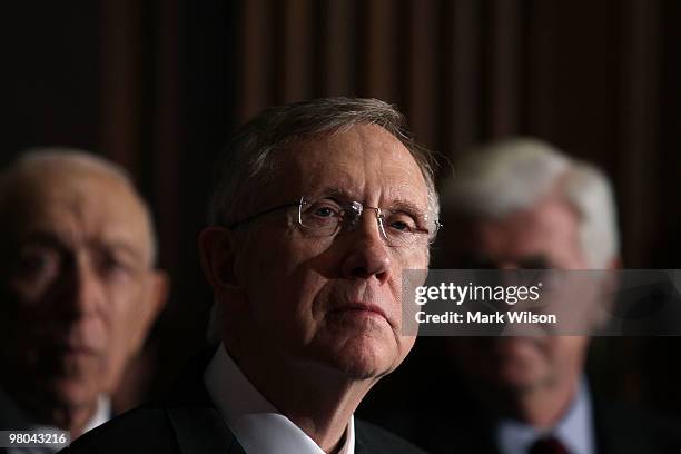 Senate Majority Leader Harry Reid speaks while flanked by Sen. Frank R. Lautenberg and Sen. Christopher Dodd after a vote on health care on Capitol...