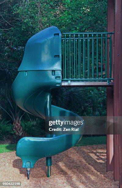 green plastic slide in a playground - wood chip texture stock pictures, royalty-free photos & images