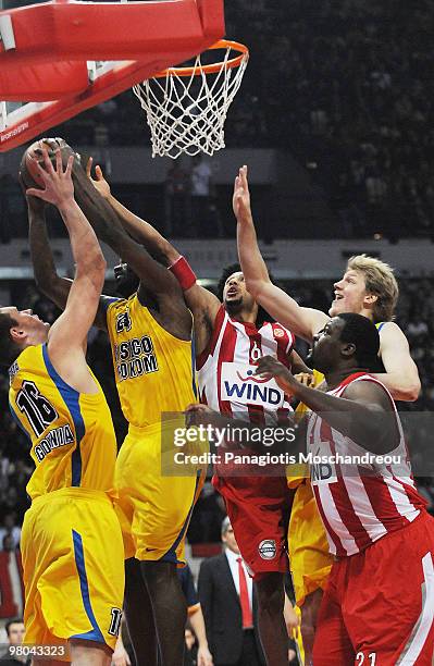 Adam Lapeta of Asseco Prokom Gdynia competes with Josh Childress of Olympiacos Piraeus during the Euroleague Basketball 2009-2010 Play Off Game 2...