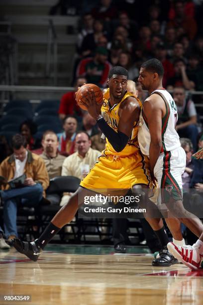 Roy Hibbert of the Indiana Pacers looks to make a move against Kurt Thomas of the Milwaukee Bucks during the game at the Bradley Center on March 14,...