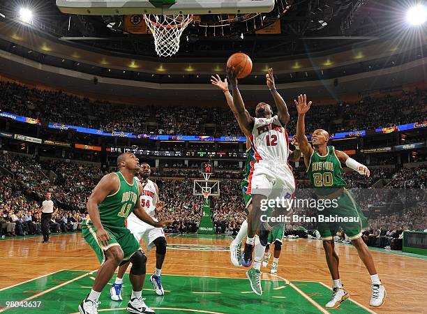 Will Bynum of the Detroit Pistons shoots a layup against Ray Allen and Glen Davis of the Boston Celtics during the game at The TD Garden on March 15,...