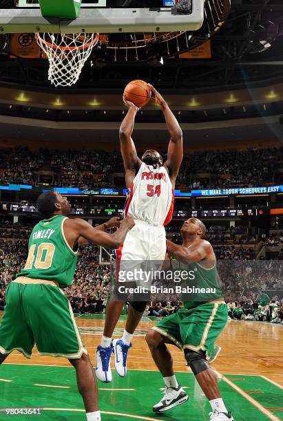 Jason Maxiell of the Detroit Pistons goes up for a shot against Glen Davis and Michael Finley of the Boston Celtics during the game at The TD Garden...