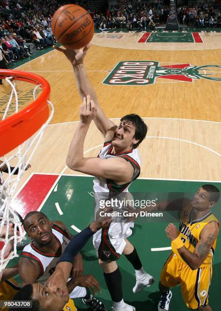 Andrew Bogut of the Milwaukee Bucks shoots a layup against Earl Watson and Danny Granger of the Indiana Pacers during the game at the Bradley Center...