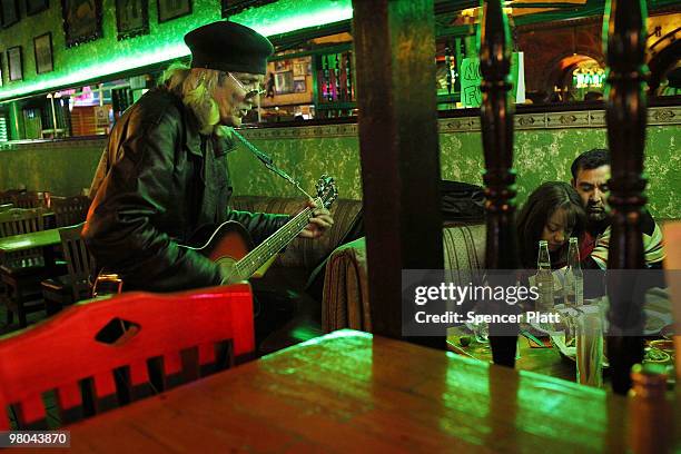 Man plays American rock songs for a couple inside the historic Kentucky Club on March 24, 2010 in Juarez, Mexico. The Kentucky Club, once a thriving...