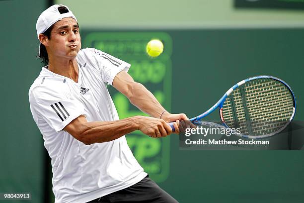 Nicolas Lapentti of Spain returns a shot against Potito Starace of Italy against during day three of the 2010 Sony Ericsson Open at Crandon Park...