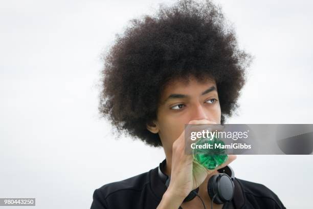 young man is relaxing on the rooftop - mamigibbs stock pictures, royalty-free photos & images