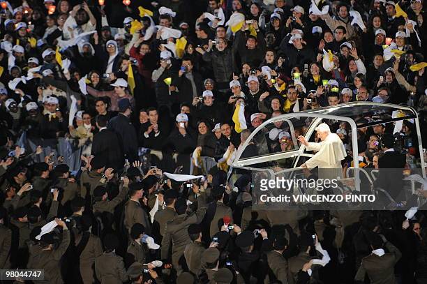 Pope Benedict XVI blesses pilgrims as he arrives on his popemobile for his meeting with the youth of Rome and the Lazio region in preparation for...