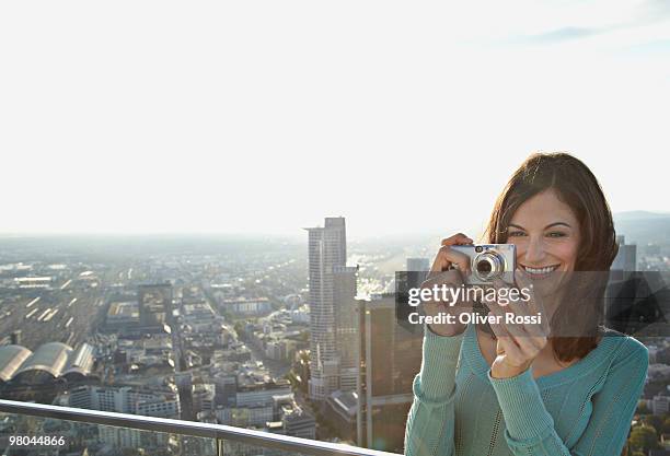 young woman with digital camera - balustrade stock photos et images de collection