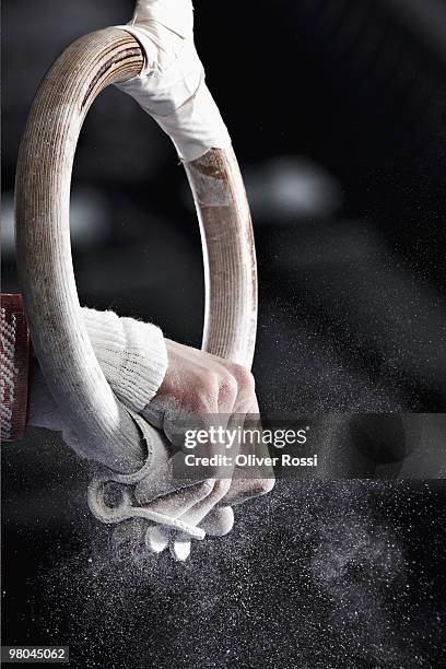 gymnast on gym rings - gymnastics equipment stock pictures, royalty-free photos & images
