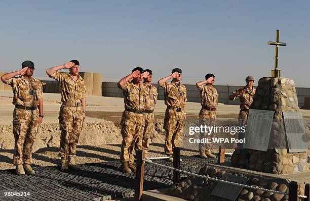 Prince Charles, Prince of Wales saluts during a memorial for British soldiers killed in Helmand at Bastion camp on March 25, 2010 in Helmand...