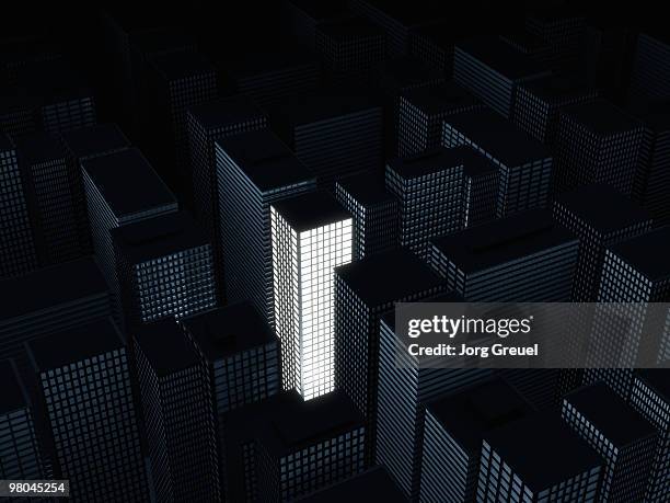 illuminated building among dark ones - jorg greuel stock illustrations