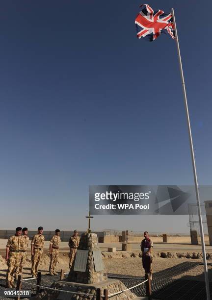 Prince Charles, Prince of Wales saluts during a memorial for British soldiers killed in Helmand at Bastion camp on March 25, 2010 in Helmand...