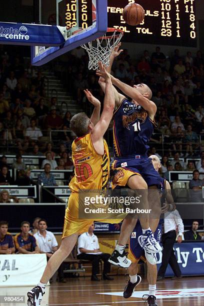 Scott McGregor of West Sydney flies over Andrew Gaze of Melbourne Tigers during the National Basketball League match between the West Sydney...