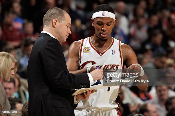 Assistant coach Michael Malone and Daniel Gibson of the Cleveland Cavaliers discuss a play during the game against the Memphis Grizzlies on February...