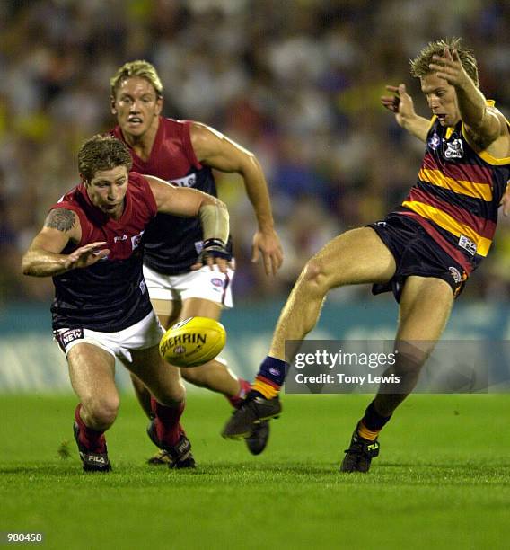 Matthew Collins for Melbourne dives on a kick from Scott Welsh for Adelaide, background is Shane Woewodin for Melbourne, in the match between the...