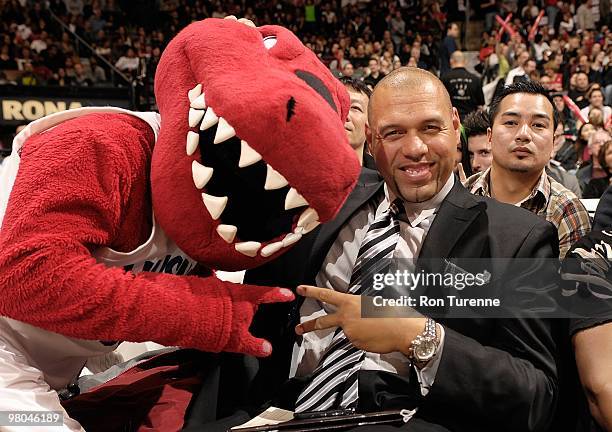 Former Toronto Raptor, Tracy Murray, poses for a portrait with mascot The Raptor during the game between the New York Knicks and the Toronto Raptors...